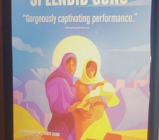 The poster for "A Thousand Splendid Suns," with a painting of two women holding a baby with a sun in the back