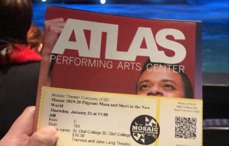 A photo of a red program reading "Atlas" in front of a stage