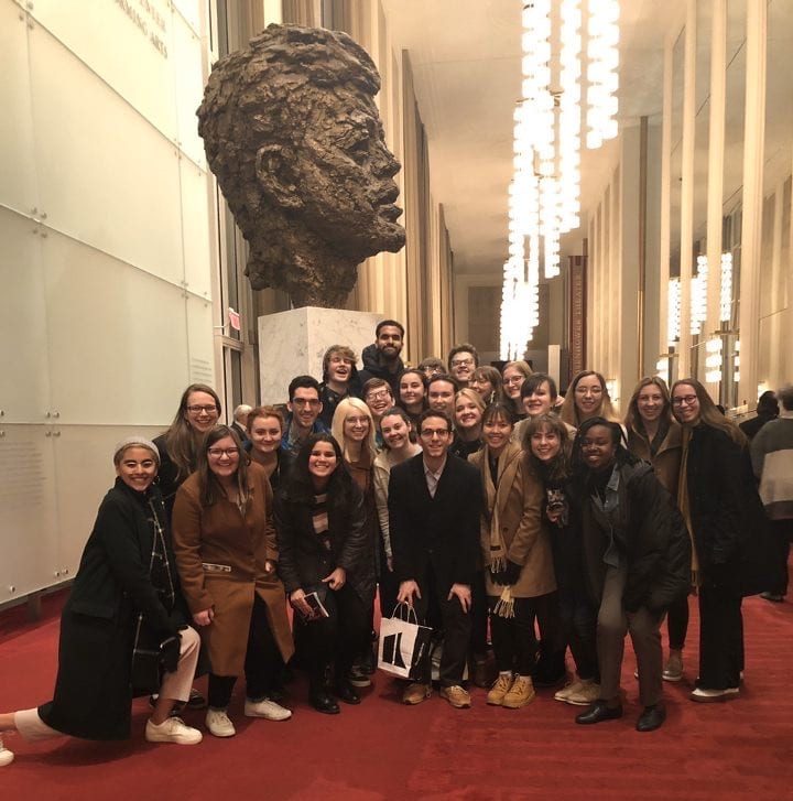 The St. Olaf group in front of a sculpture of John F. Kennedy 