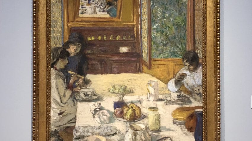 A pastel painting with a group of people sitting around a dinner table full of food 