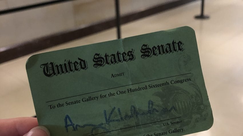 A green ticket reading "United States Senate" in front of a tan floor and black line separator