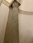 A pillar in a tan alcove wall.