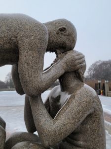 A depiction of a couple at the base of the monolith.