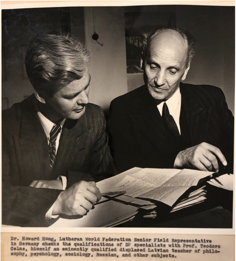 Dr. Hong and displaced Professor Celms check DP dossiers. Original Caption: "Dr. Howard Hong, Lutheran Wolrd Federation Senior Field Representative in Germany checks the qualifications of DP specialists with Prof. Teodors Celms, himself an eminently qualified displaced Latvian teacher of philosophy, psychology, sociology, Russian, and other subjects."
