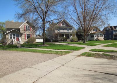 Street view of driveway and houses.