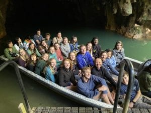 Group photo in a boat at the Waitomo Glow Worm Cave